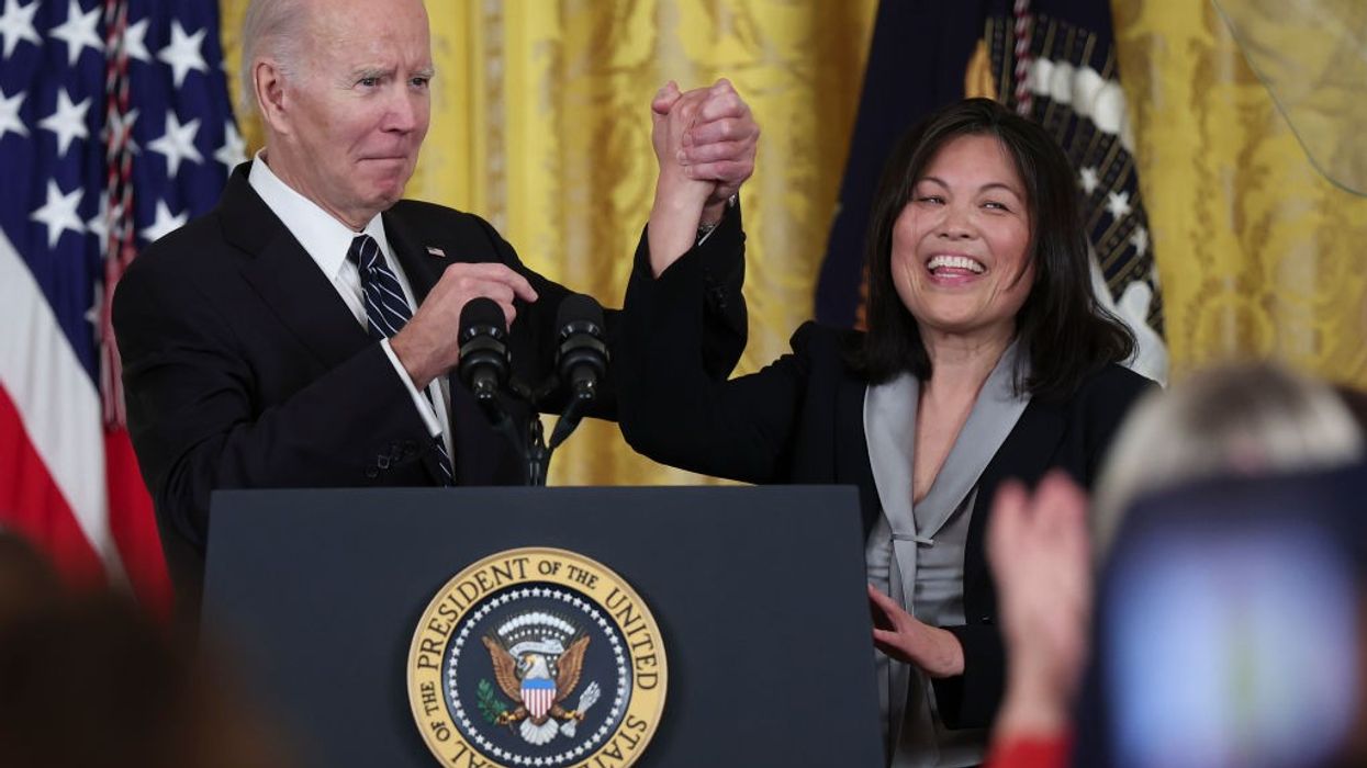 U.S. President Joe Biden holds hands with his then-nominee for U.S. secretary of labor, Julie Su