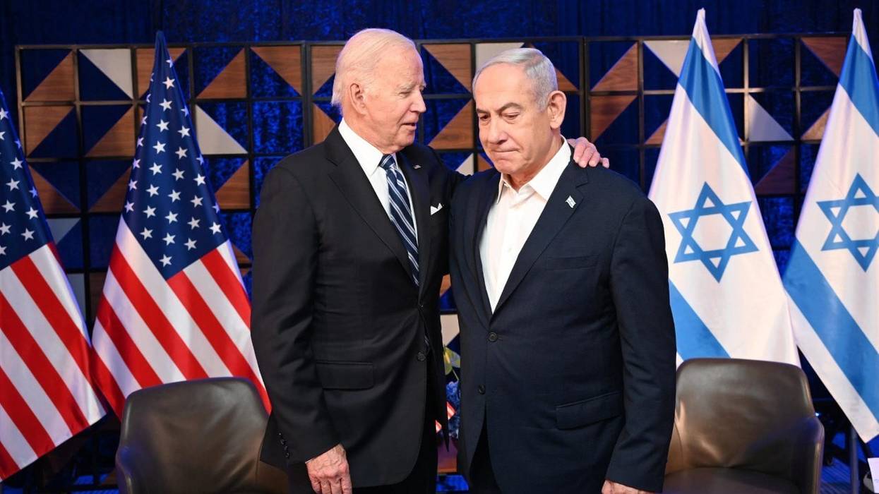 U.S. President Joe Biden puts his arm around Israeli Prime Minister Benjamin Netanyahu's shoulder
