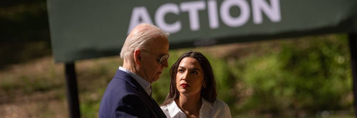 U.S. President Joe Biden speak with Rep. Alexandria Ocasio-Cortez (D-N.Y.)