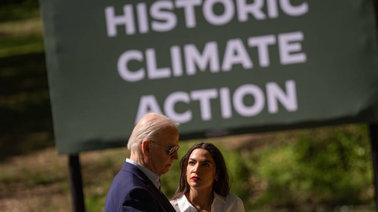 U.S. President Joe Biden speak with Rep. Alexandria Ocasio-Cortez (D-N.Y.)