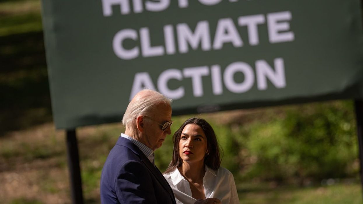 U.S. President Joe Biden speak with Rep. Alexandria Ocasio-Cortez (D-N.Y.)