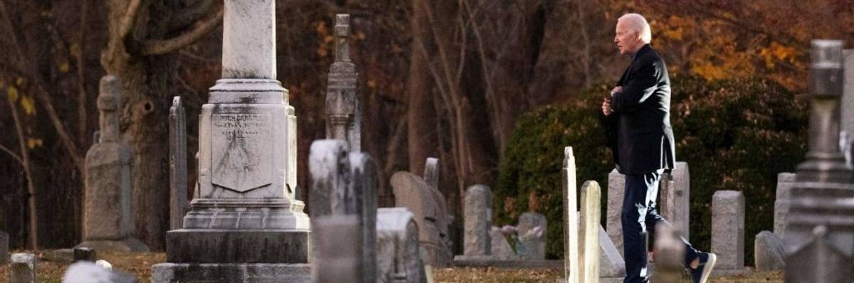 U.S. President Joe Biden walks in a cemetery