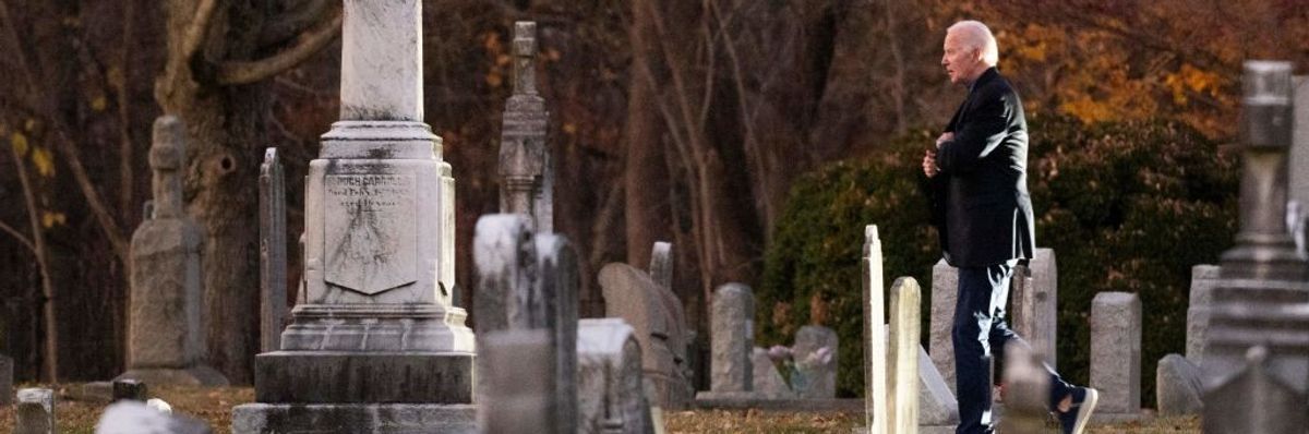 U.S. President Joe Biden walks in a cemetery