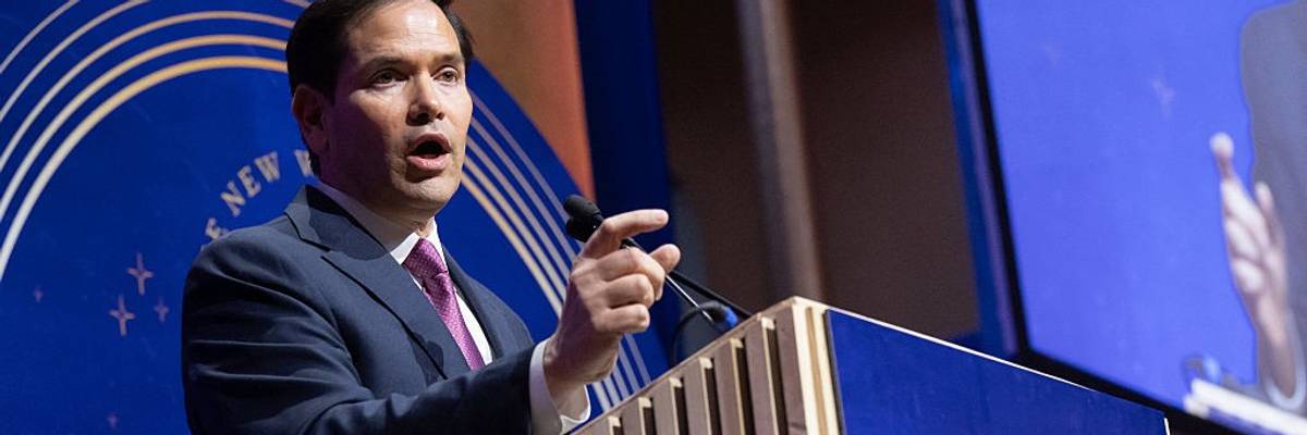 U.S. Secretary of State Marco Rubio points while speaking at a podium