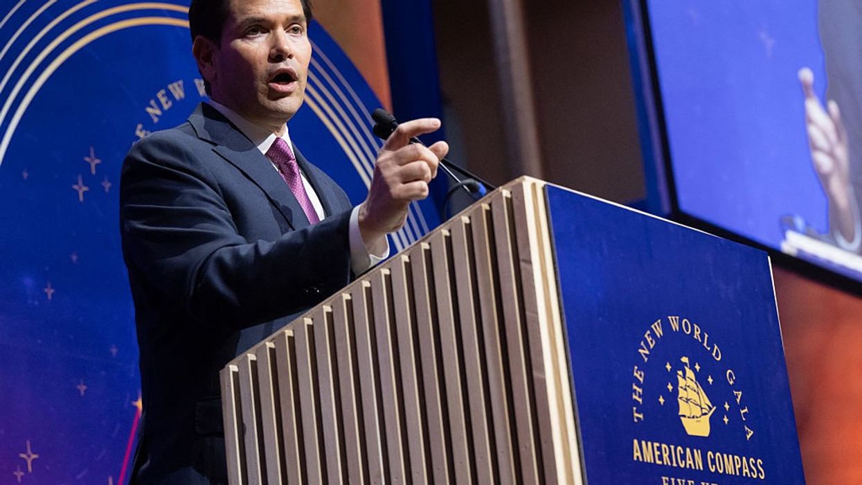 U.S. Secretary of State Marco Rubio points while speaking at a podium