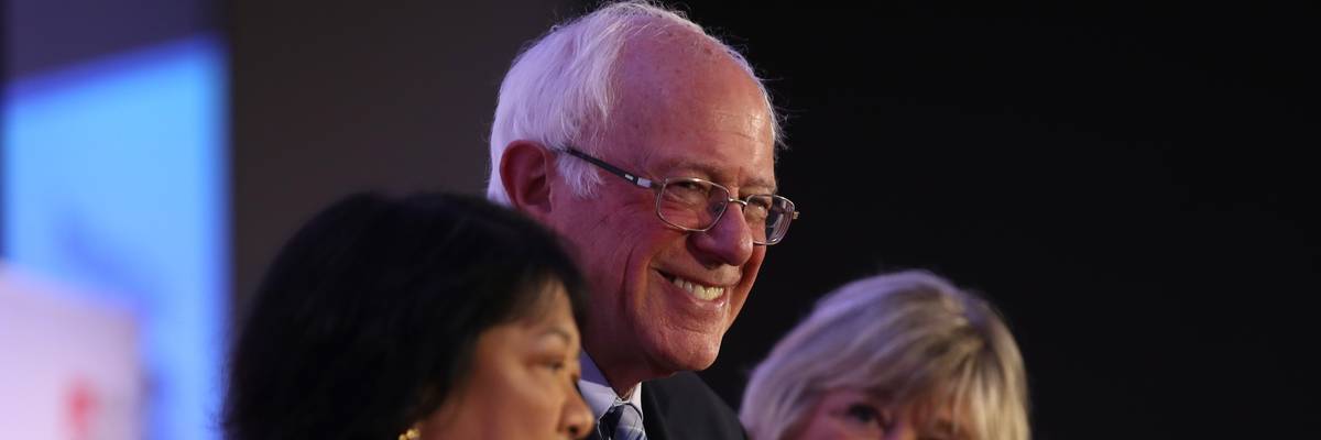 U.S. Sen. Bernie Sanders (C) (I-Vt.) looks on during a campaign rally