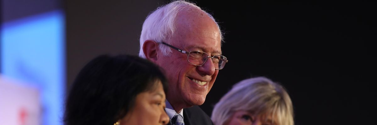 U.S. Sen. Bernie Sanders (C) (I-Vt.) looks on during a campaign rally 