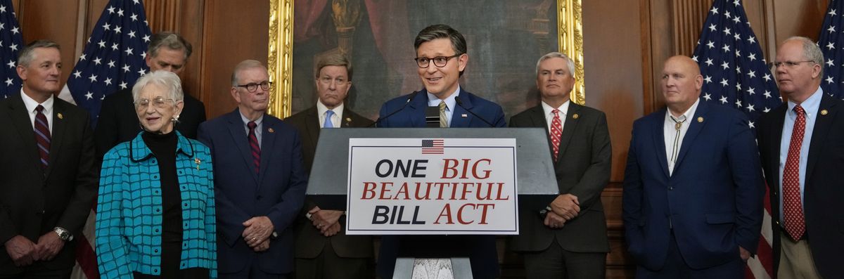 U.S. Speaker of the House Mike Johnson stands above podium reading, "One Big Beautiful Bill Act."