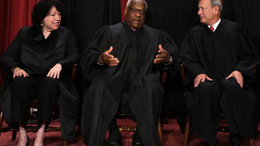 U.S. Supreme Court Justice Clarence Thomas speaks with fellow justices