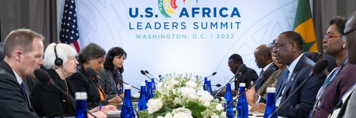 U.S. Treasury Secretary Janet Yellen and President of Senegal Macky Sall face each other across a table.