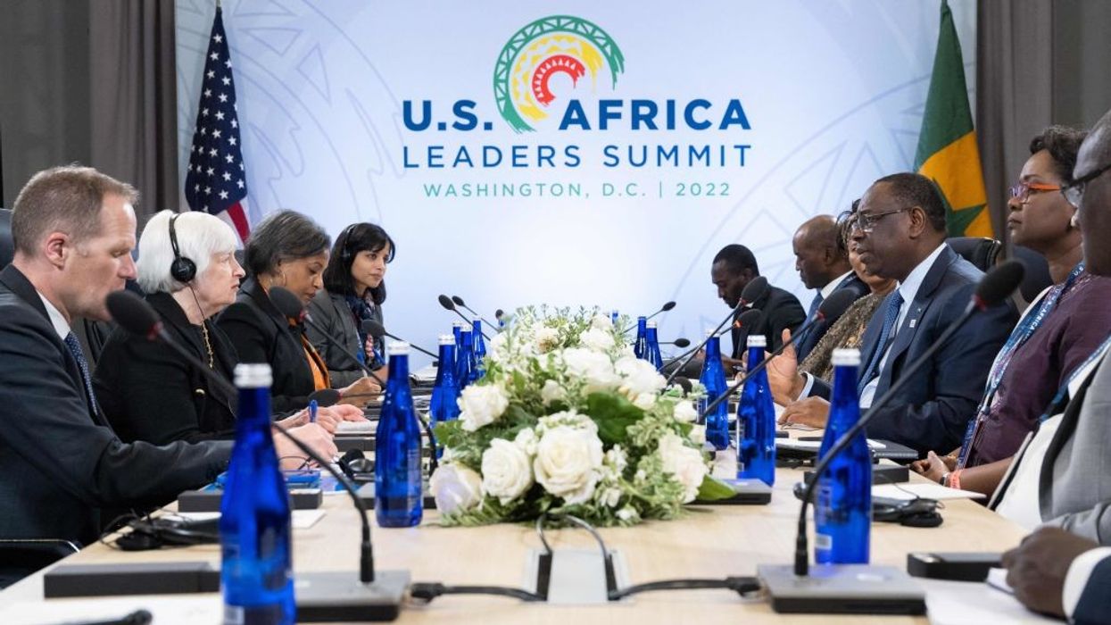 U.S. Treasury Secretary Janet Yellen and President of Senegal Macky Sall face each other across a table.