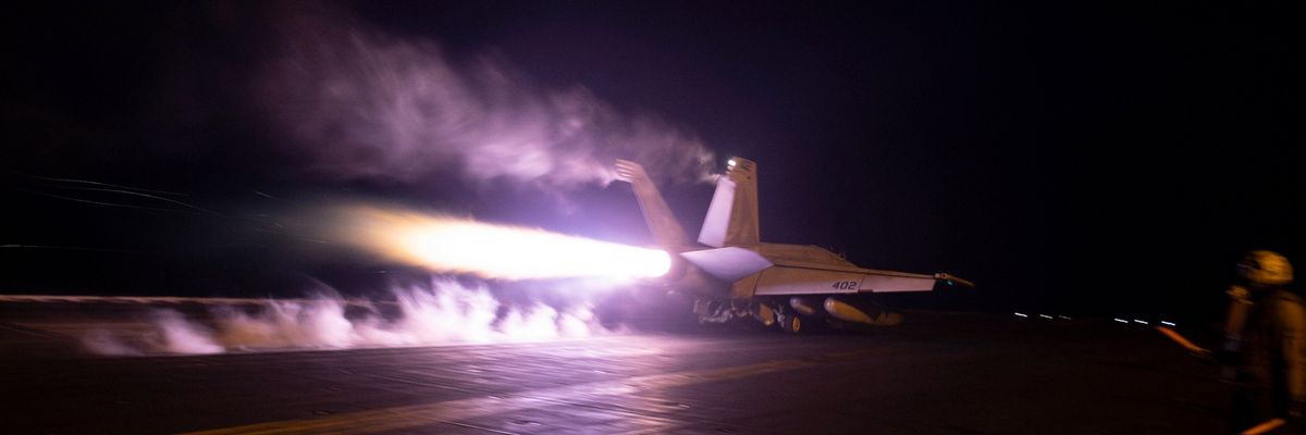 U.S. warplane takes off from aircraft carrier at night