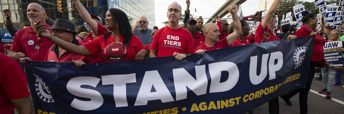 UAW president Shawn Fain marches