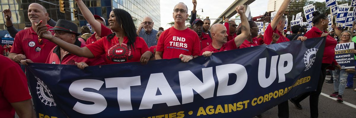 UAW president Shawn Fain marches