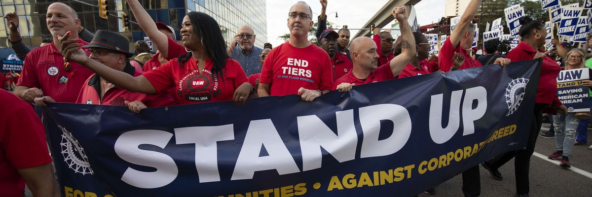 UAW president Shawn Fain marches