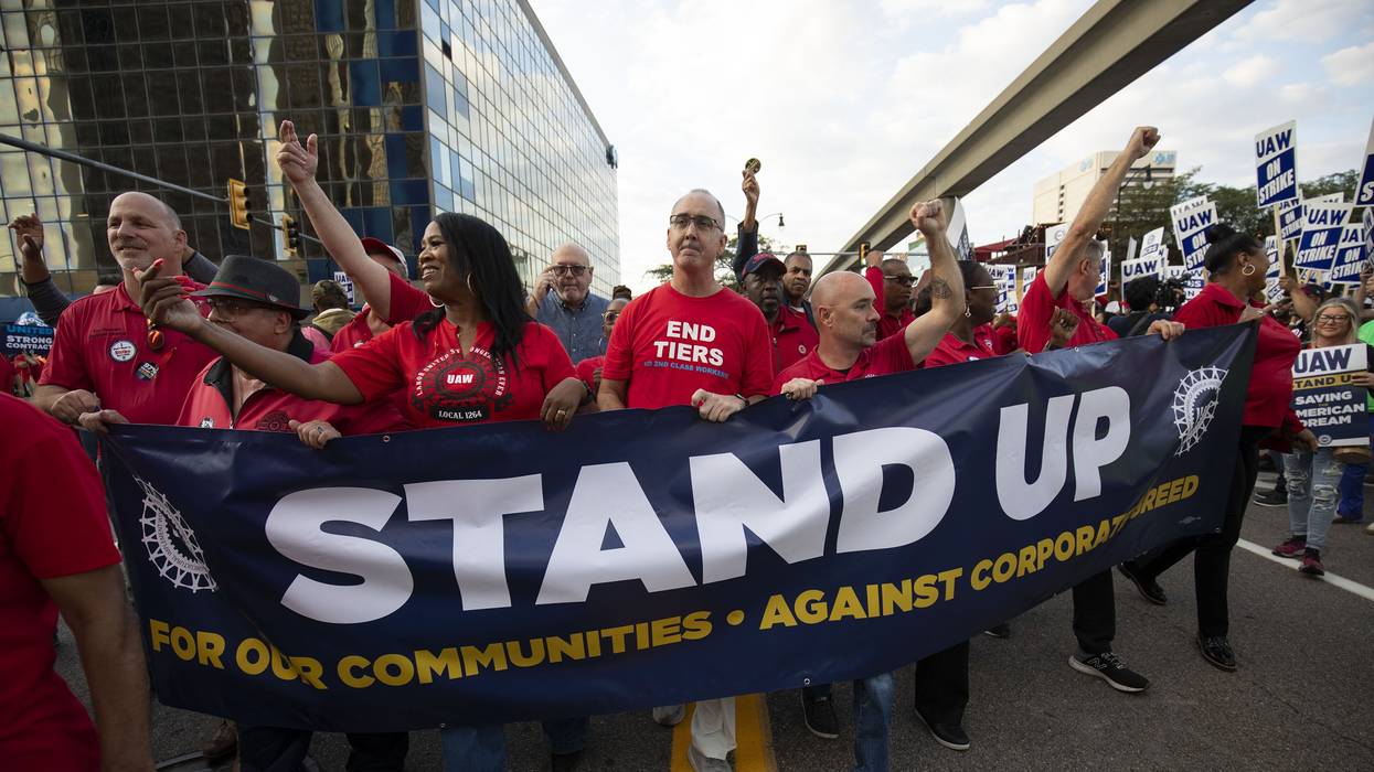 UAW president Shawn Fain marches