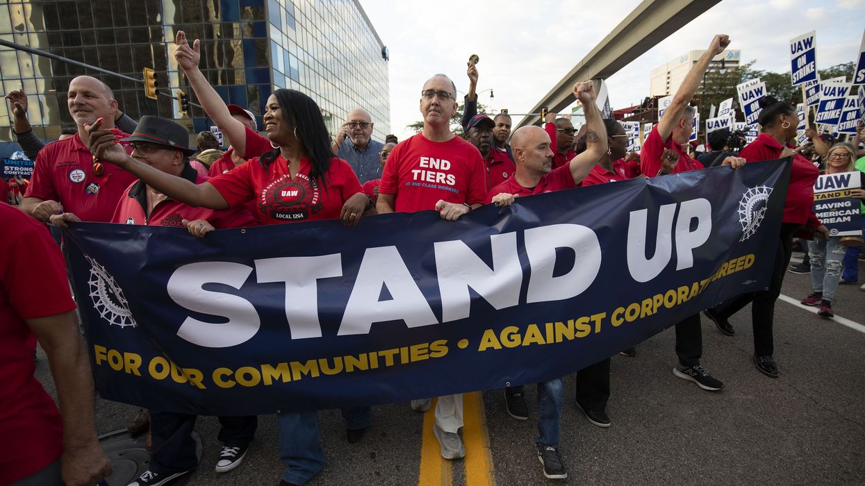 UAW president Shawn Fain marches