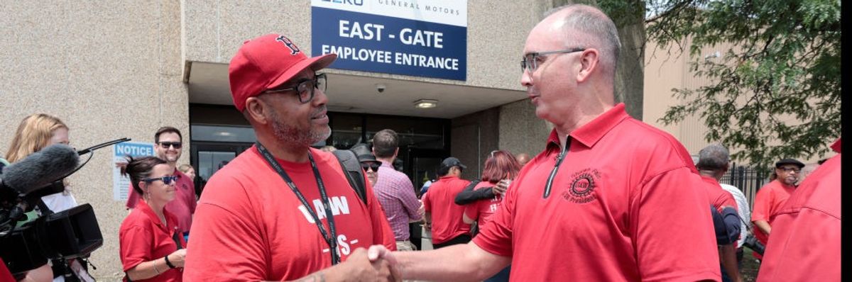 UAW President Shawn Fain shakes hands with a member.