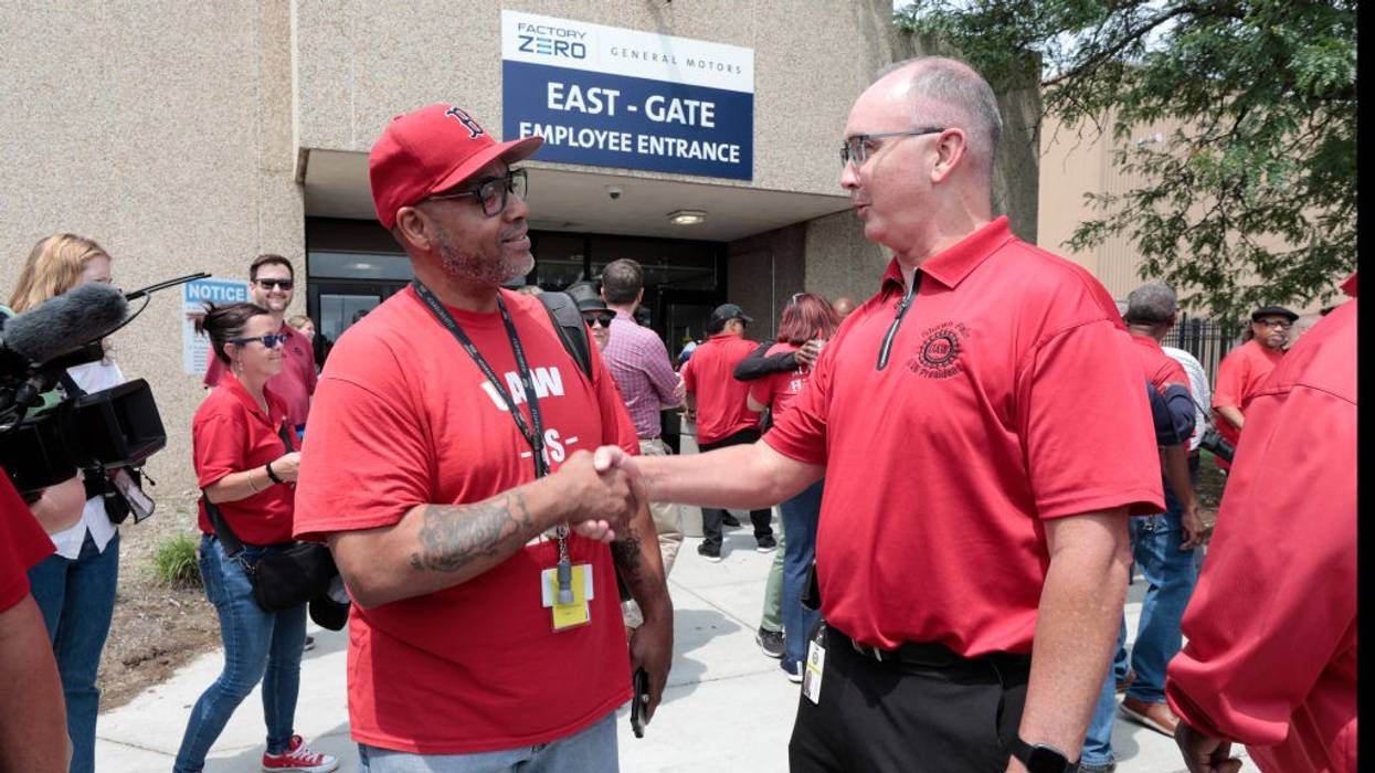 UAW President Shawn Fain shakes hands with a member.