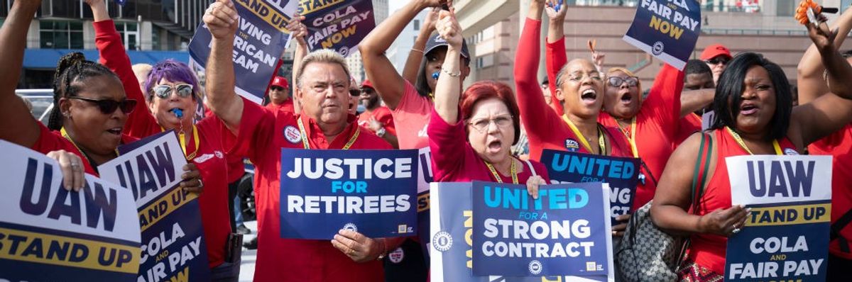 UAW workers protest with signs