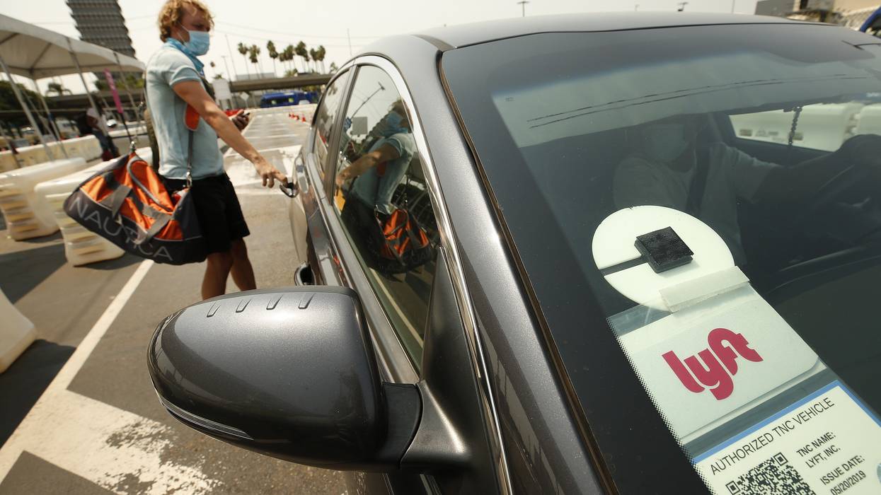 Uber and Lyft drivers with the Mobile Workers Alliance held a moving rally as part of a statewide day of action to demand that both ride-hailing companies follow California law and grant drivers basic employee rights and to denounce the corporations effort