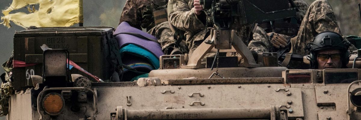Ukraine soldiers sitting on a tank