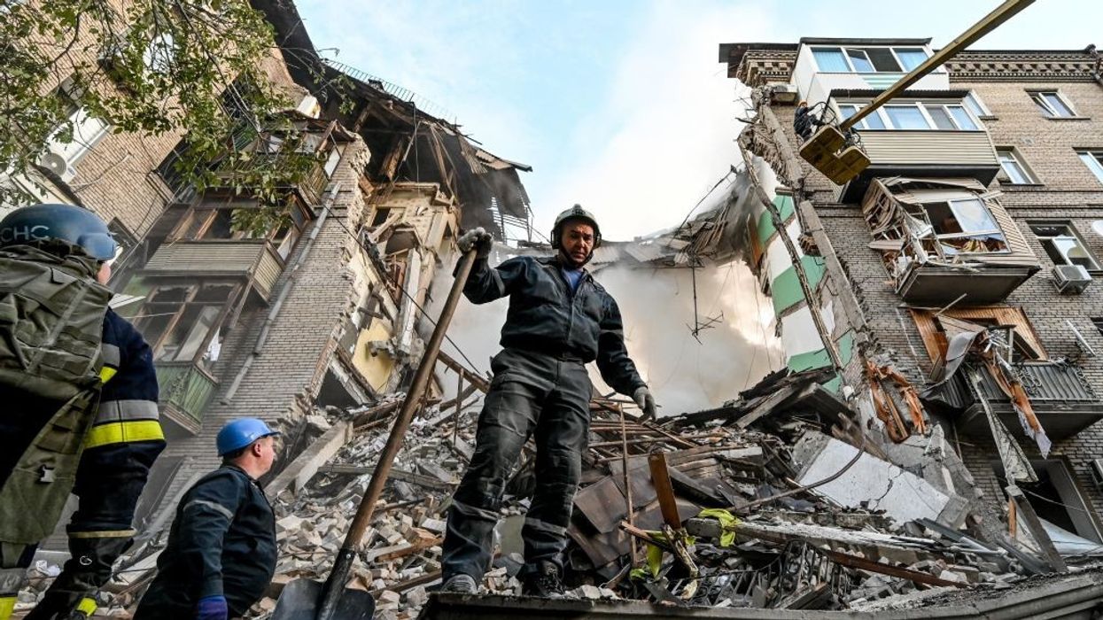 Ukrainian firefighters push out a fire after a strike in Zaporizhzhia on October 6, 2022, amid the Russian invasion of Ukraine.