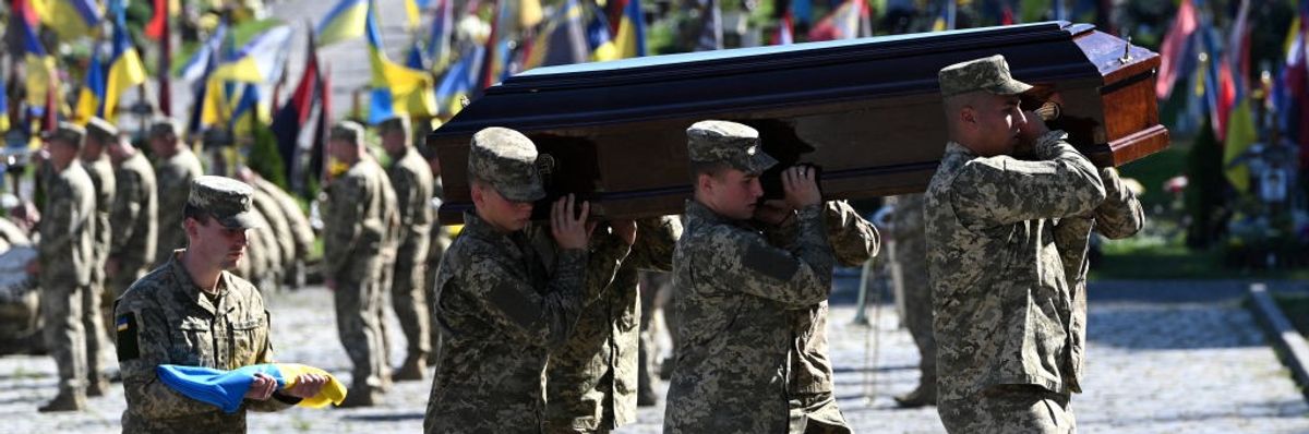 Ukrainian soldiers carry the coffin of Ukrainian serviceman