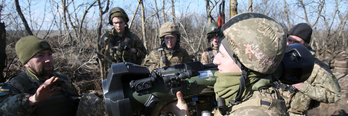 Ukrainian soldiers examine an anti-tank missile