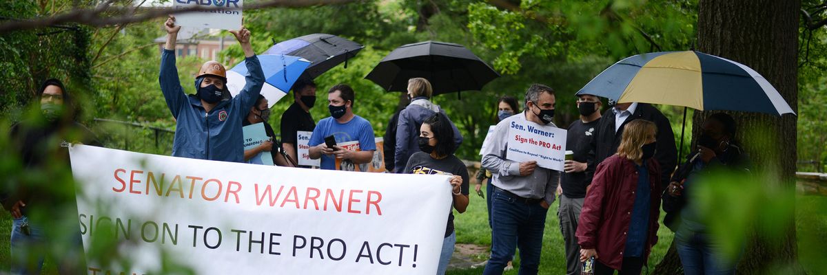 Union members demonstrate outside the home of Sen. Mark Warner (D-Va.), one of three holdouts in the Senate Democratic Caucus who has yet to co-sponsor the PRO Act, in Alexandria, Virginia on May 5, 2021.