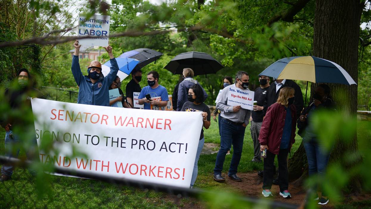 Union members demonstrate outside the home of Sen. Mark Warner