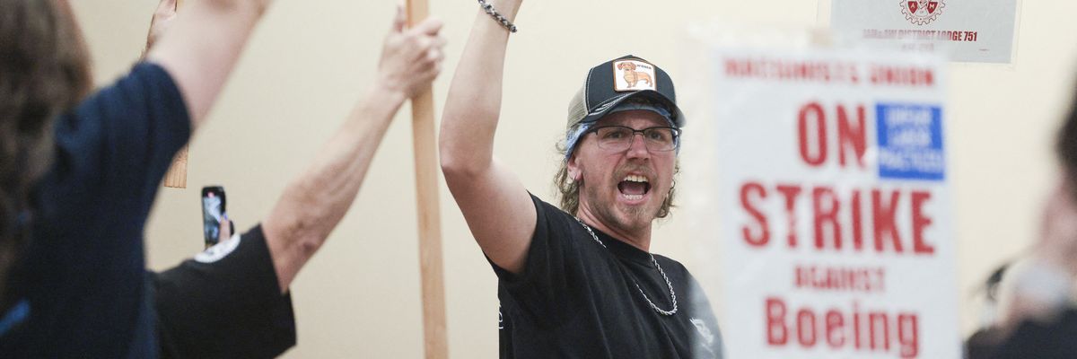 Union members react as the Aerospace Machinists District 751 union announced that it would go on strike