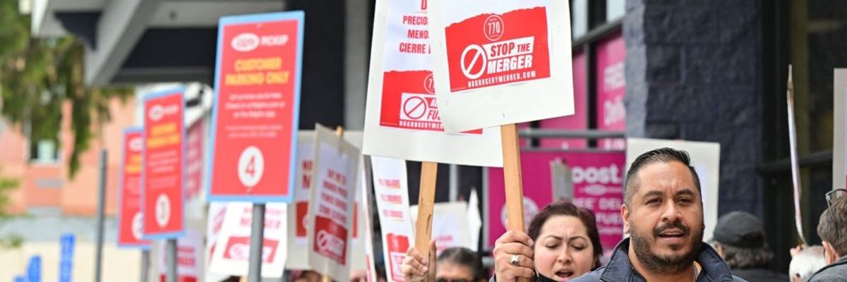 Unionized grocery store workers rally to oppose the proposed merger of Kroger and Albertsons