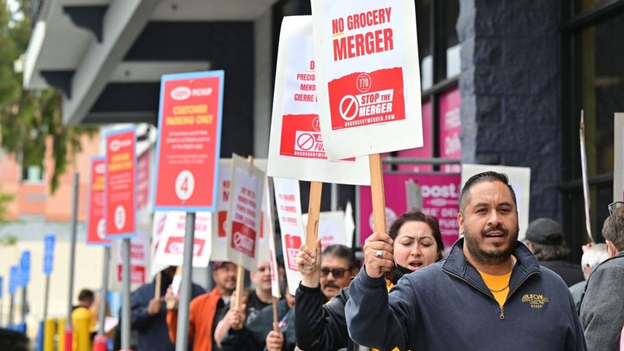 Unionized grocery store workers rally to oppose the proposed merger of Kroger and Albertsons