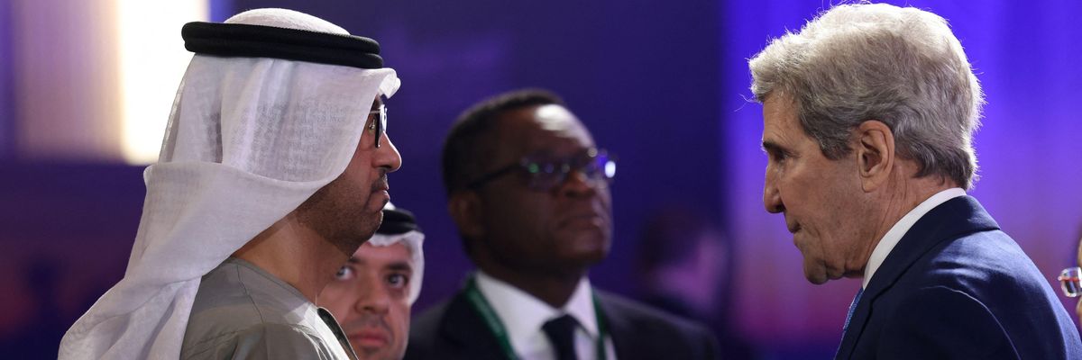 United Arab Emirates' minister of state and CEO of the Abu Dhabi National Oil Company (ADNOC), Sultan Ahmed al-Jaber (L), speaks to U.S. Presidential Envoy for Climate John Kerry
