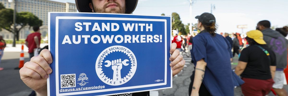United Auto Workers members and others gather for a rally