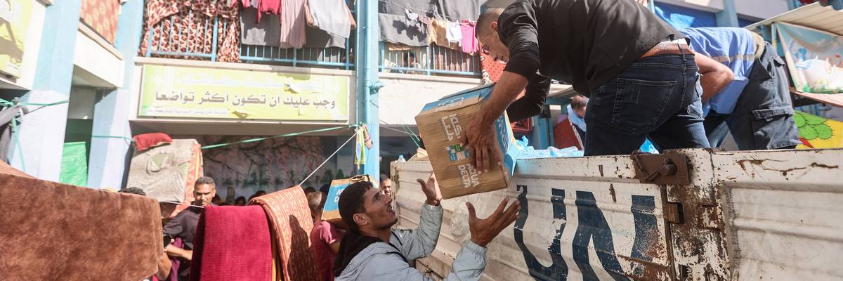 UNRWA workers distribute aid