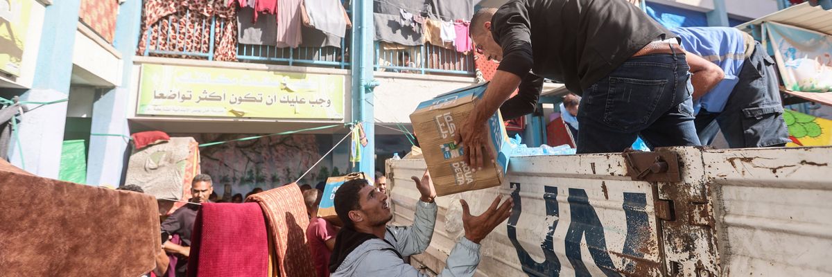 UNRWA workers distribute aid