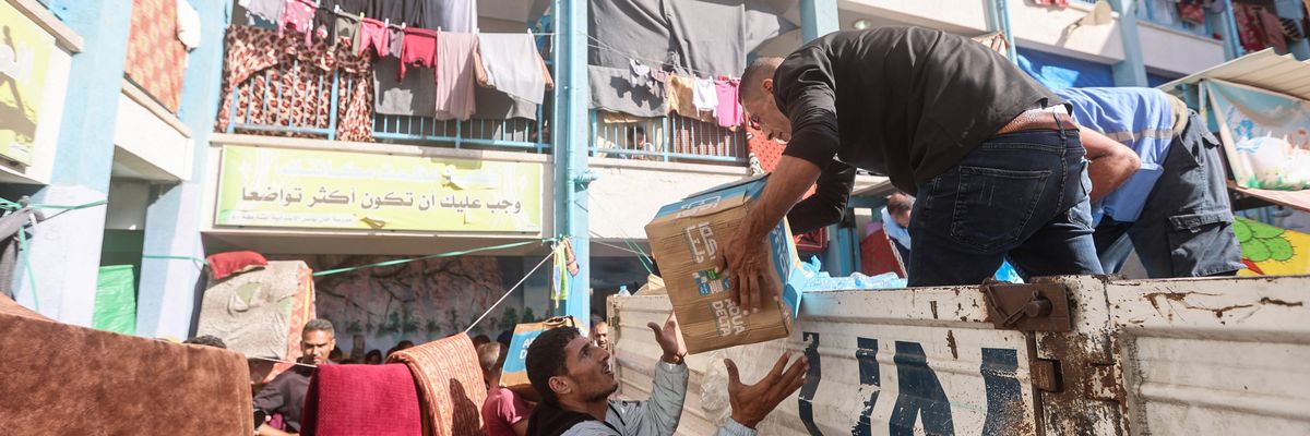 UNRWA workers distribute aid