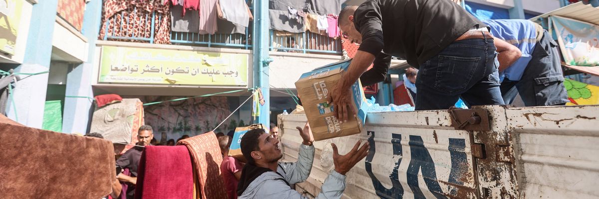 UNRWA workers distribute aid 