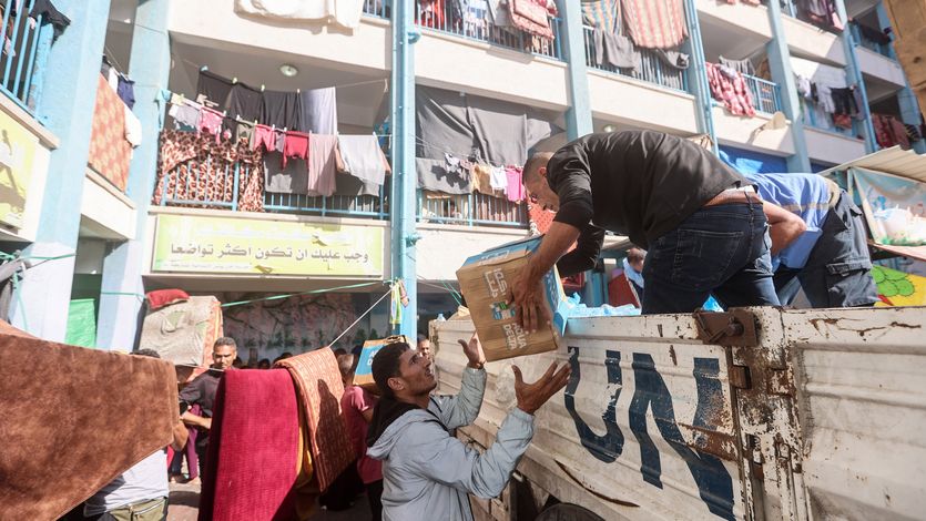 UNRWA workers distribute aid
