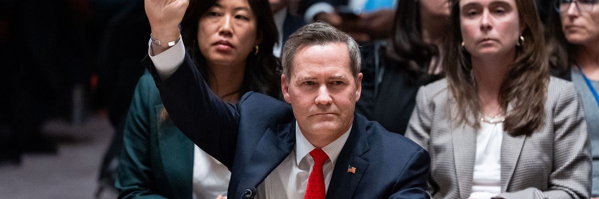 US Ambassador to the UN raises his hand to vote in favor of a resolution establishing a so-called internaitonal stabilization force in Gaza