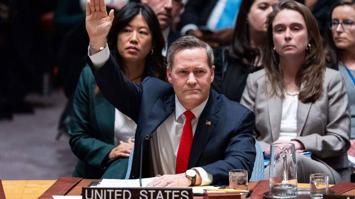 US Ambassador to the UN raises his hand to vote in favor of a resolution establishing a so-called internaitonal stabilization force in Gaza