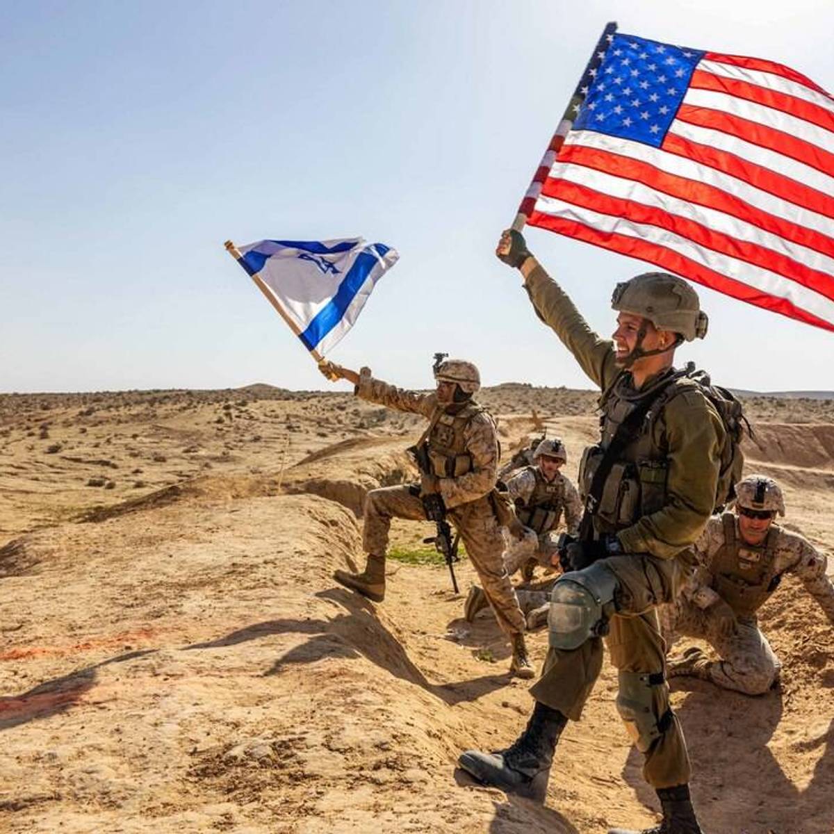 US and Israeli soldiers wave their countries' flags during a desert training exercise