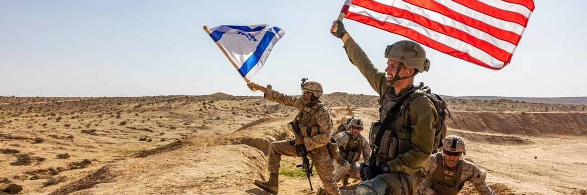 US and Israeli soldiers wave their countries' flags during a desert training exercise