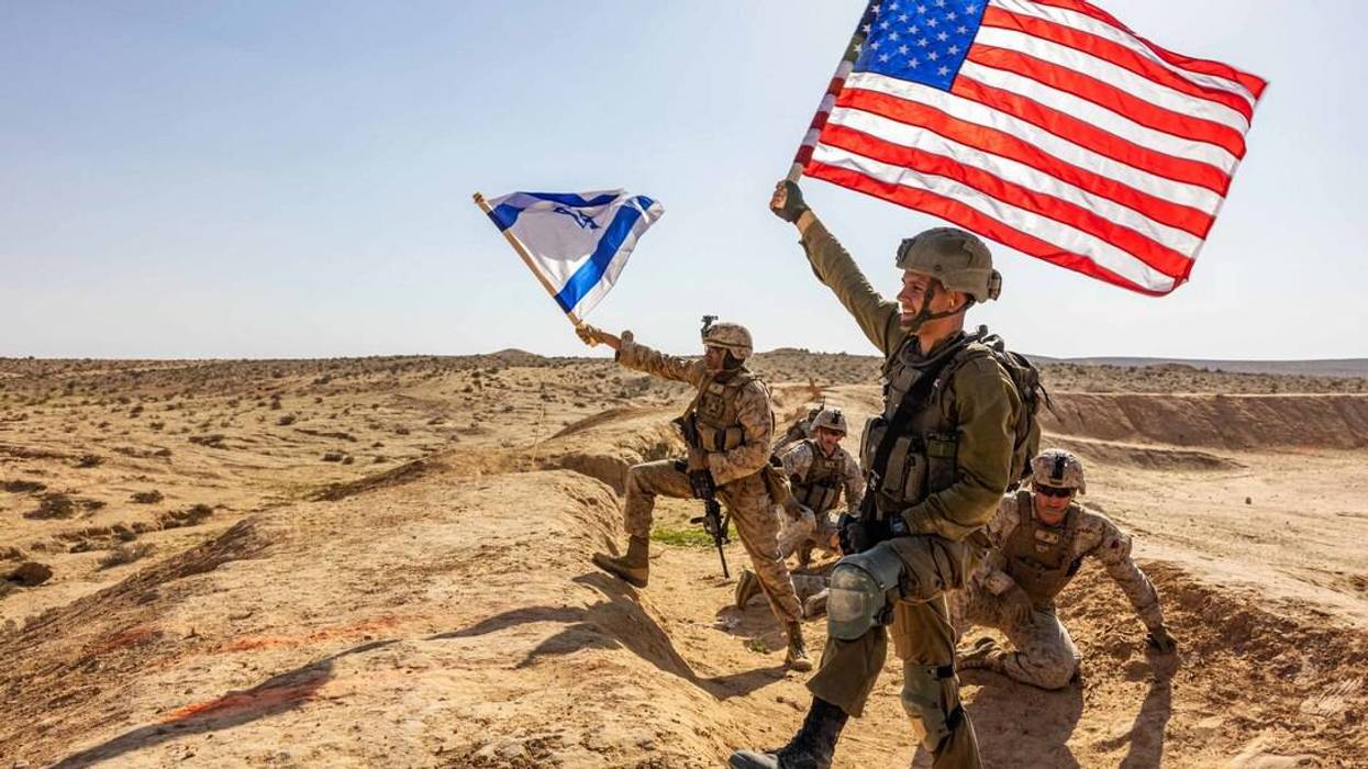 US and Israeli soldiers wave their countries' flags during a desert training exercise