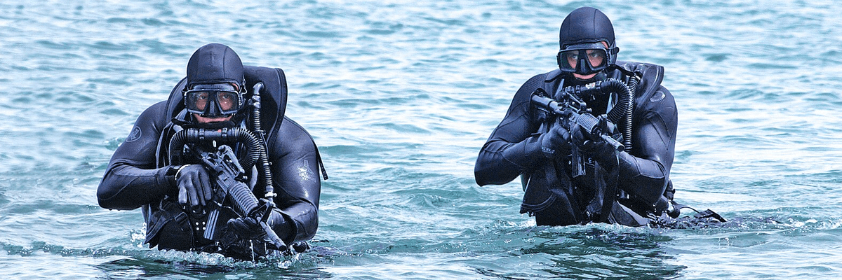 US Navy SEALs in the water with guns