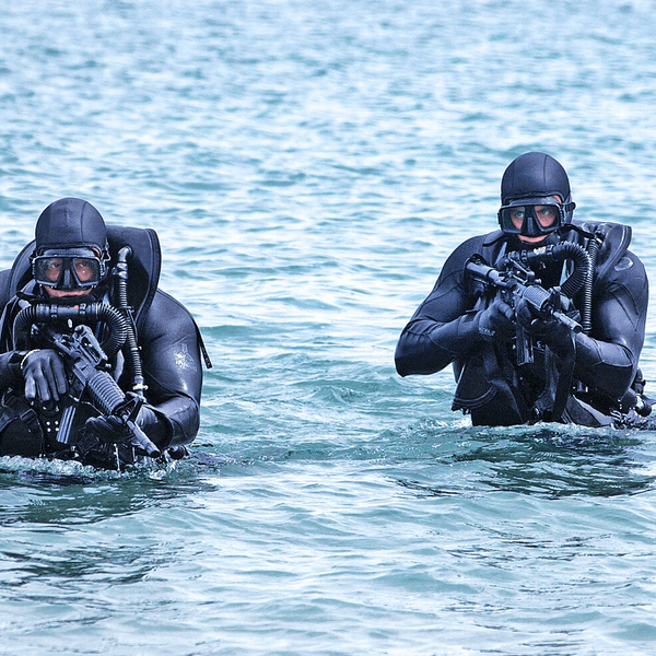 US Navy SEALs in the water with guns