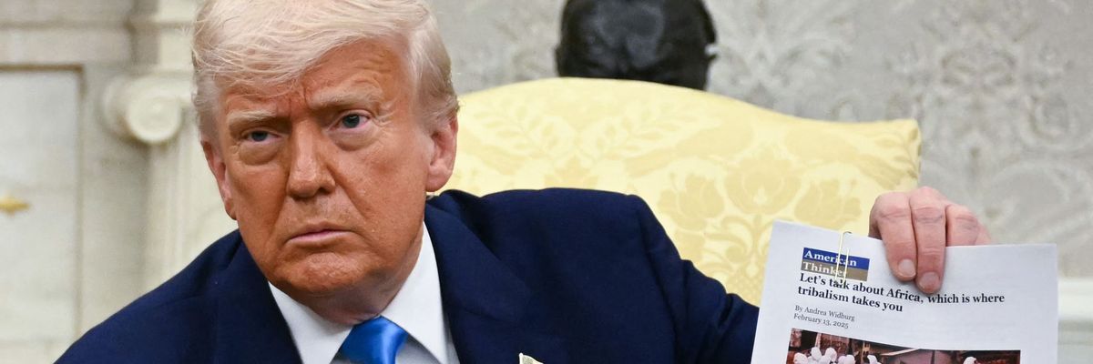US President Donald Trump displays an article about Afrikaners as he meets with South African President Cyril Ramaphosa