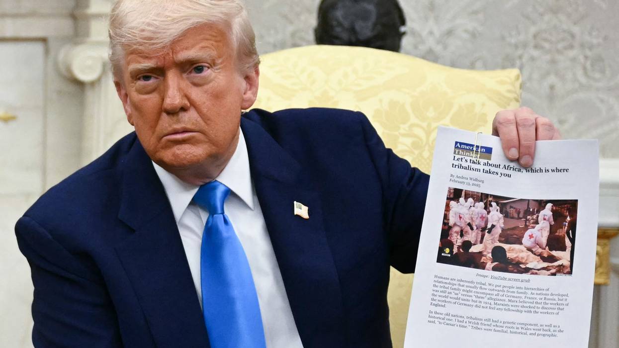 US President Donald Trump displays an article about Afrikaners as he meets with South African President Cyril Ramaphosa